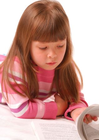 Little girl reading book over white backgroundの写真素材