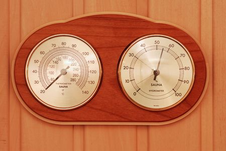 Thermometer device in sauna over wooden backgroundの写真素材
