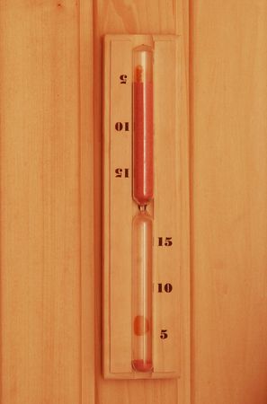 Hourglass in sauna over wooden background             の写真素材