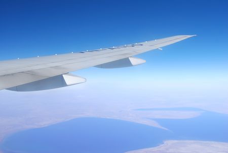 Plane wing against blue skyの写真素材
