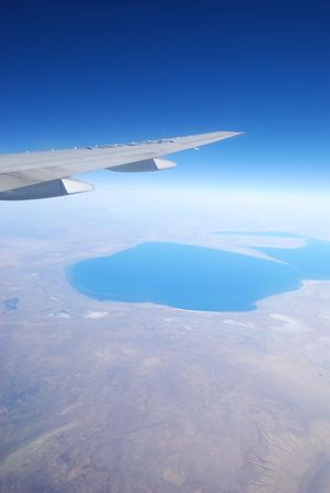 Plane wing against blue skyの写真素材