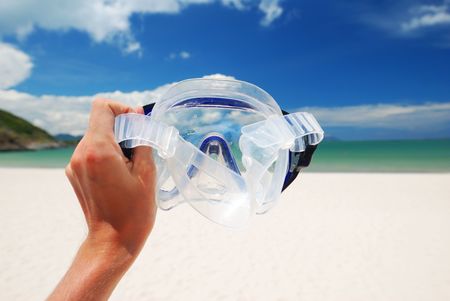 Snorkel equipment against beach and skyの写真素材