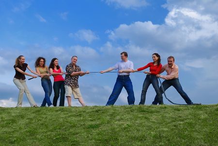 Group of happy people pulling the ropeの写真素材