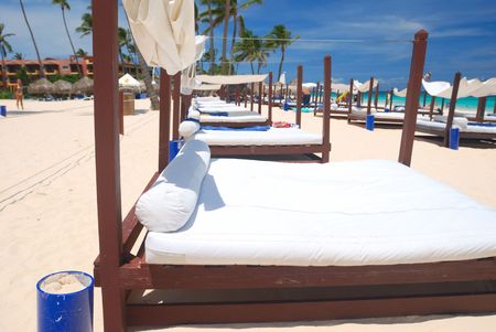 Beautiful caribbean beach with chaise lounge in Dominican Republicの写真素材