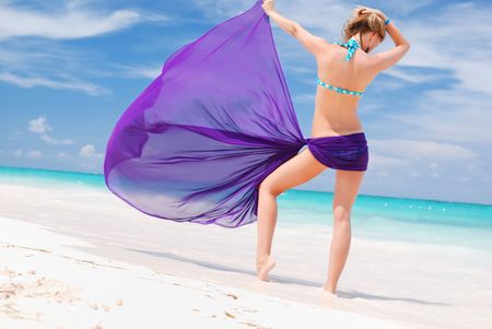 Woman with sarong on caribbean beachの写真素材