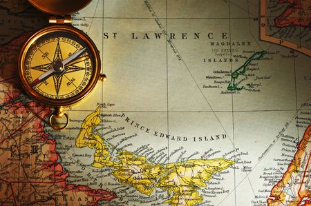 Antique brass compass over old Canadian map backgroundの写真素材
