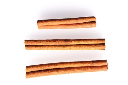 Cinnamon sticks over white backgroundの写真素材