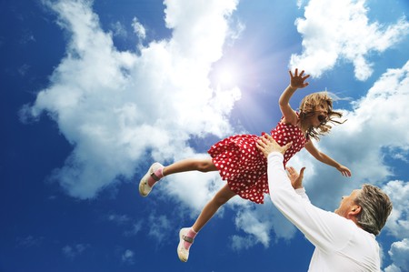 Father and daughter against sky の写真素材