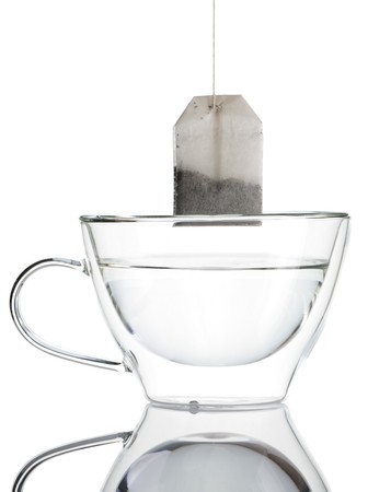 Teabag in the cup with hot waterの写真素材