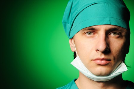 Surgeon with mask over greenの写真素材