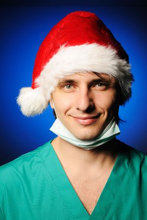 Surgeon with mask in Santa's hat smilingの写真素材