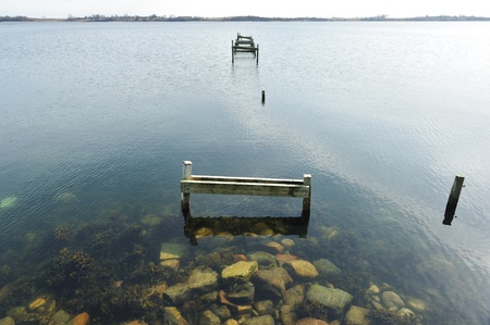 Old jetty wooden walkway pier on the lake