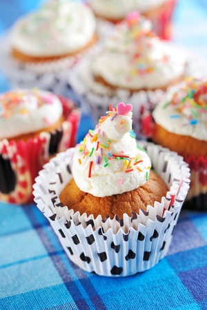Cupcakes with whipped cream and icingの写真素材