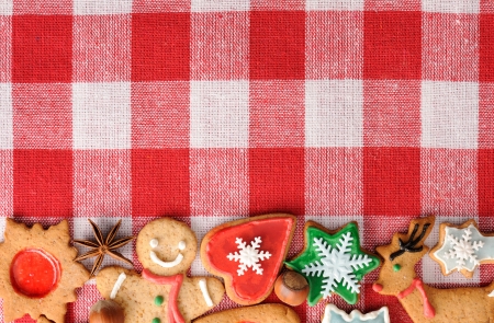 Christmas gingerbread cookies over tableclothの写真素材