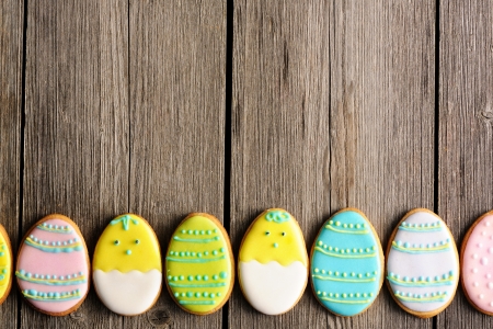 Easter homemade gingerbread cookie over wooden tableの写真素材