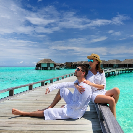 Couple on a tropical beach jetty at Maldivesのeditorial素材