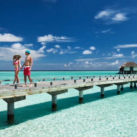 Couple on a tropical beach jetty at Maldivesのeditorial素材