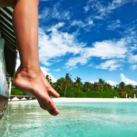 Woman's legs at beach jettyの写真素材