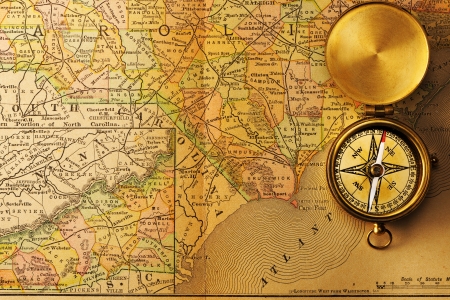 Antique brass compass over old XIX century mapの写真素材