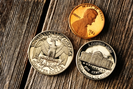 Three US cent coins over wooden backgroundの写真素材