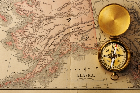 Antique brass compass over old XIX century mapの写真素材