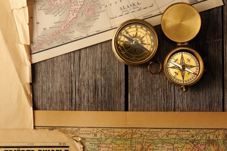 Antique brass compasses over old mapの写真素材