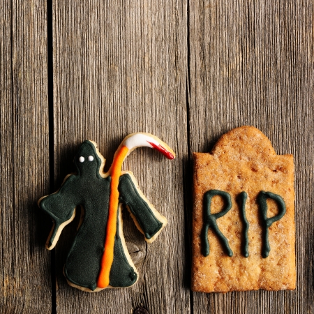 Halloween homemade gingerbread cookies over wooden tableの写真素材
