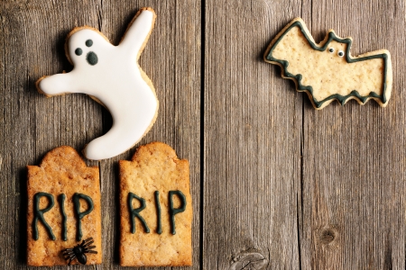 Halloween homemade gingerbread cookies over wooden tableの写真素材
