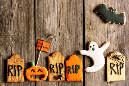 Halloween homemade gingerbread cookies over wooden tableの写真素材