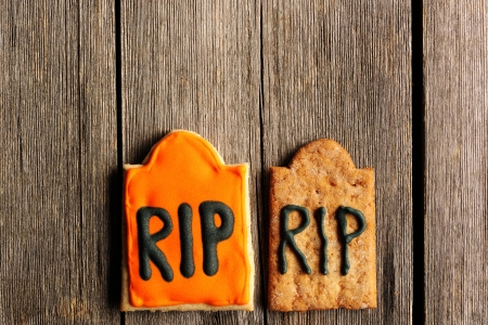 Halloween homemade gingerbread cookies over wooden tableの写真素材