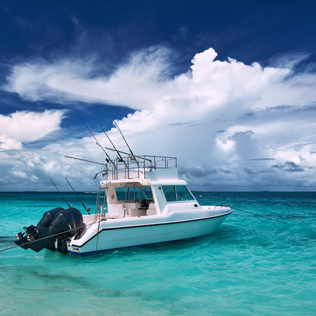 Beautiful island beach with motor boat at Maldivesの写真素材