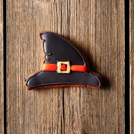 Halloween homemade gingerbread cookie over wooden table