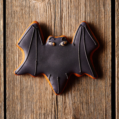 Halloween homemade gingerbread cookie over wooden tableの写真素材