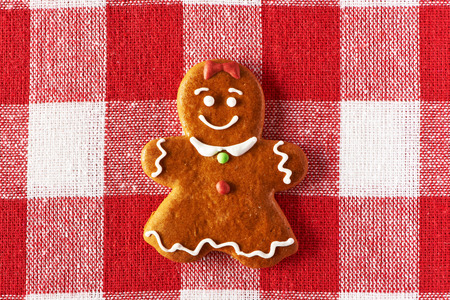 Christmas homemade gingerbread girl on tablecloth
