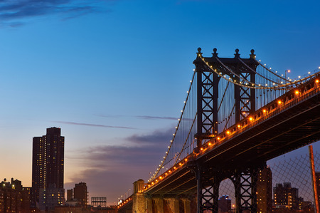 Manhattan Bridge and skyline silhouette view from Brooklyn in New York City at sunset