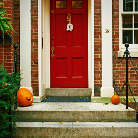 Pumpkins near the door during Halloween seasonの写真素材