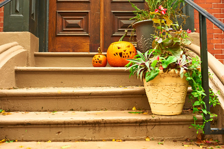 Pumpkins near the door during Halloween seasonの写真素材