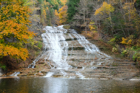 Autumn scene landscape of waterfalls at Buttermilk Falls State Parkの写真素材