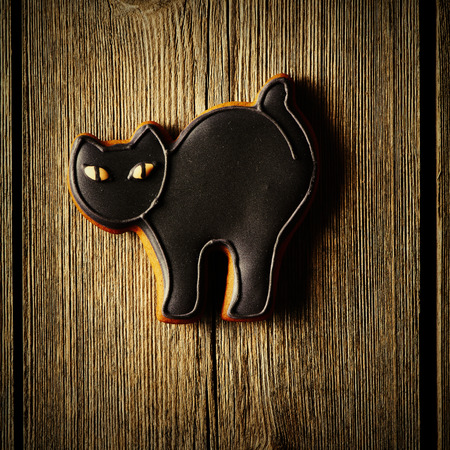 Halloween homemade gingerbread cookie over wooden tableの写真素材