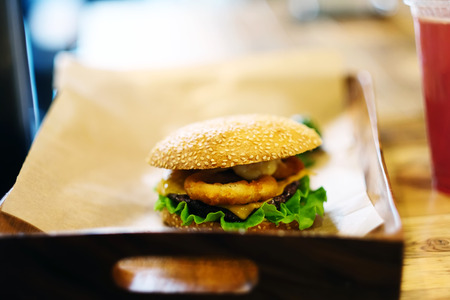 Cheeseburger on sesame buns and drinkの写真素材