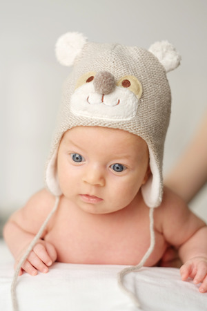 Two months old newborn baby in funny hatの写真素材