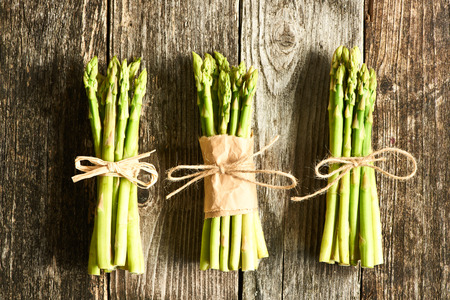 Bunch of asparagus over rustic wooden backgroundの写真素材