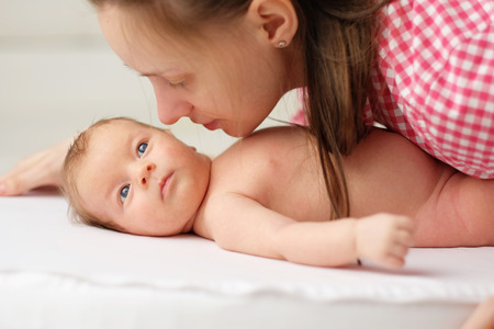 One month old newborn baby with his motherの写真素材