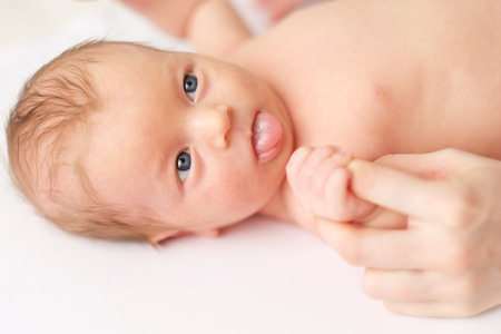 One month old newborn baby with his motherの写真素材