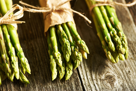 Bunch of asparagus over rustic wooden backgroundの写真素材