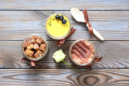 Assorted jar cakes on wooden tableの写真素材