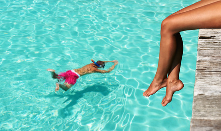 Woman's legs at beach jettyの写真素材