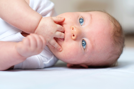 Four months old baby with blue eyesの写真素材