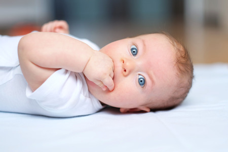 Four months old baby with blue eyesの写真素材