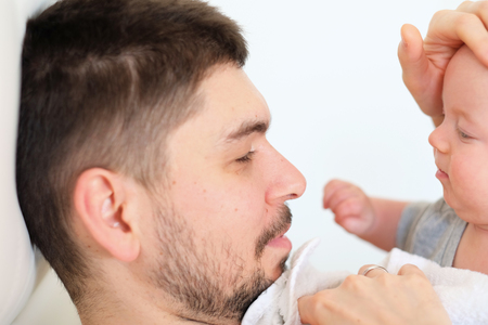 Newborn baby with his father. Shallow depth of field.の写真素材